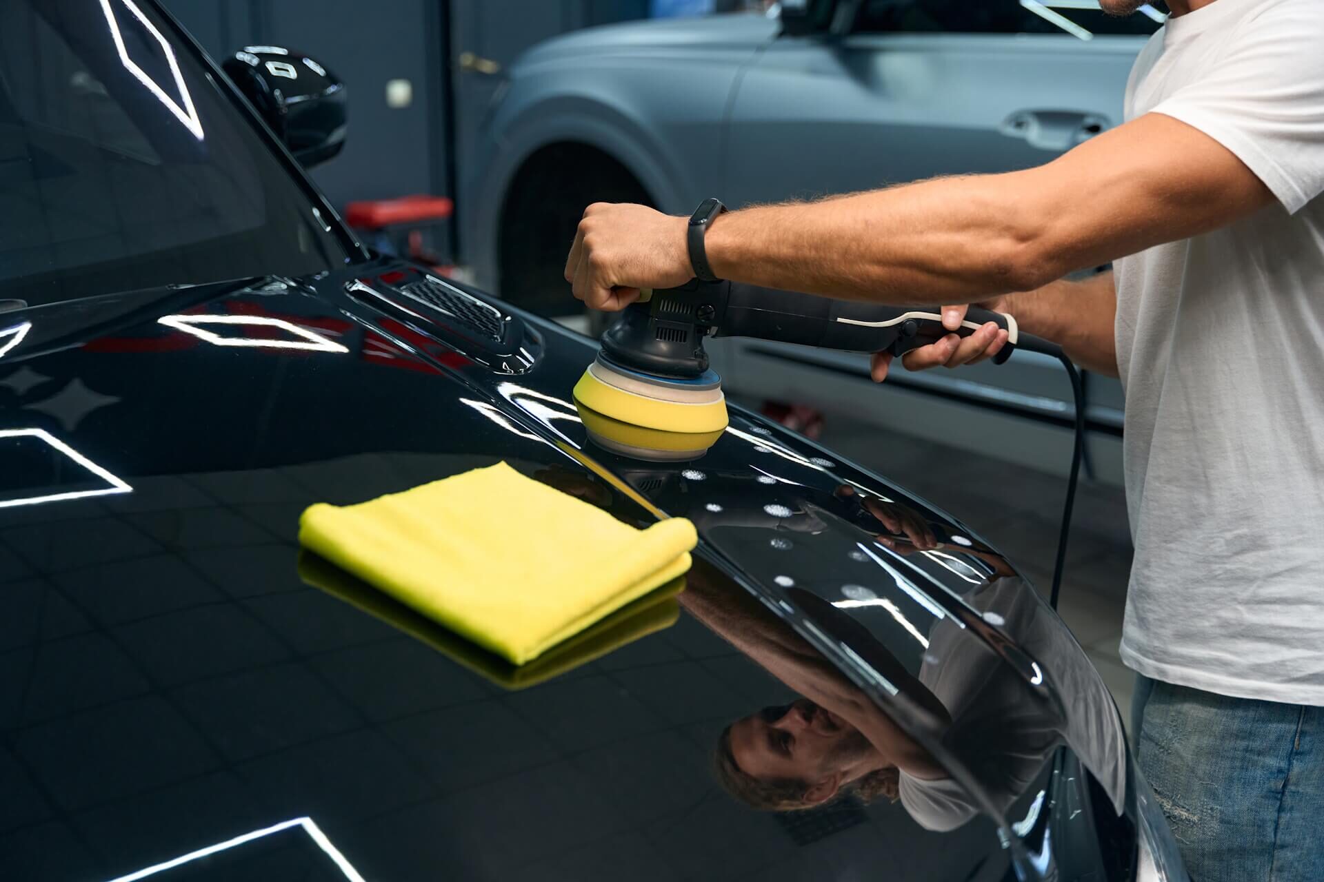 Technician applying ceramic coating to sports car