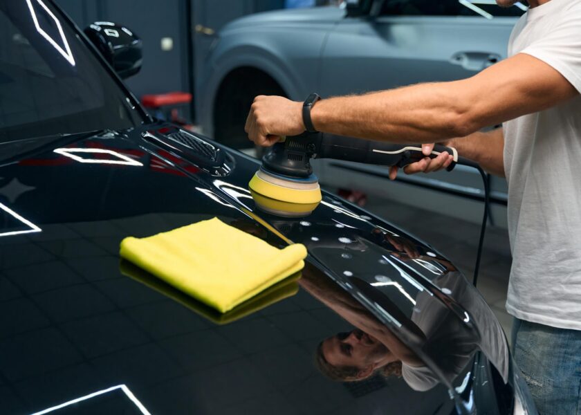 Technician applying ceramic coating to sports car