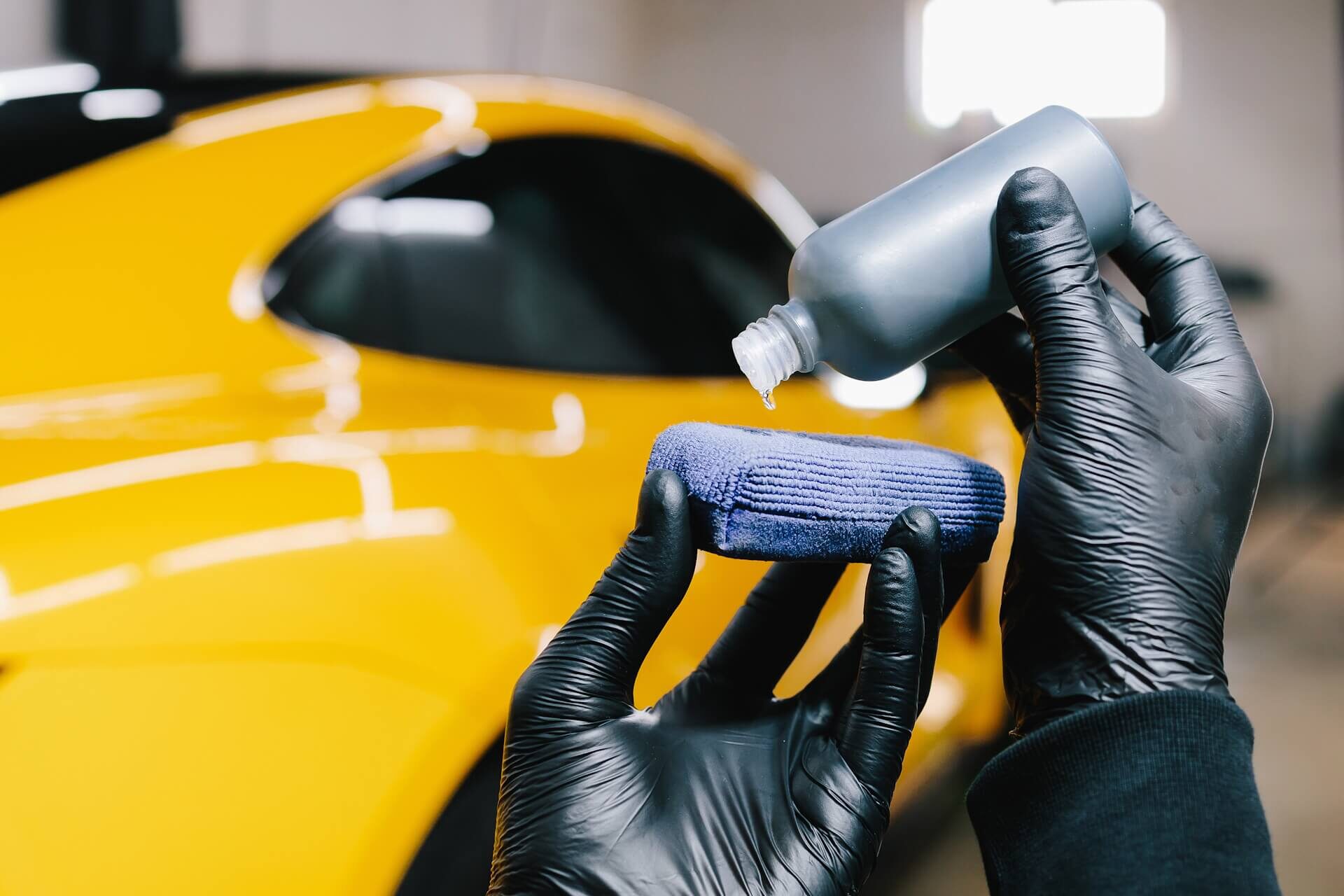 Automotive Specialist Applying Ceramic Coating to Sports Car